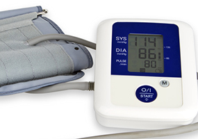 Blutdruckmessgerät mit Manschette auf weißem Hintergrund zeigt Wert des Blutdrucks und des Pulses an.